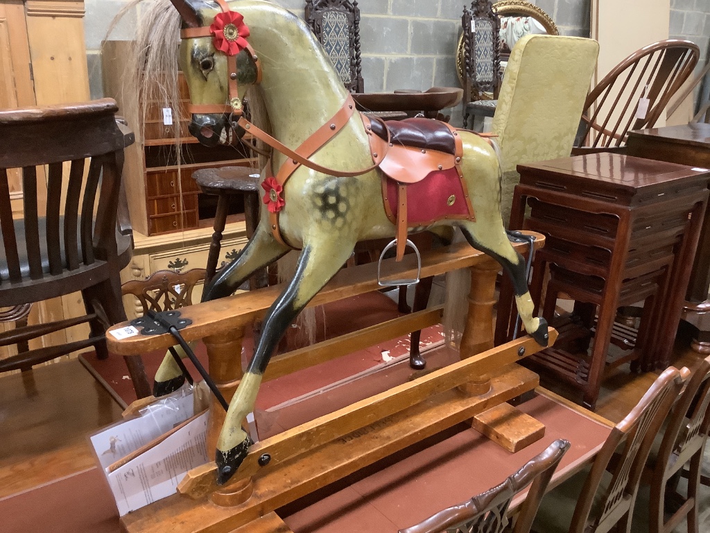 A 1920's F.H. Ayres painted wood rocking horse, on a trestle stand, fully restored in 2009 by Stevenson Bros., length 112cm height 100cm